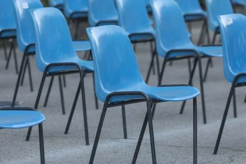 Rows and columns of nondescript blue plastic chairs, Spain. Foto stock