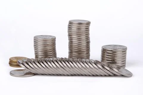 Rows and columns of white and yellow metal coins on a white background Stock Photos