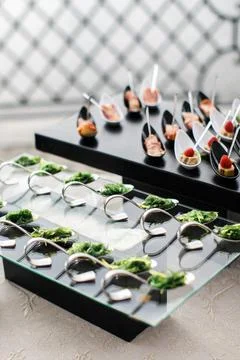 Rows of appetizers and starters on the wedding table Stock Photos