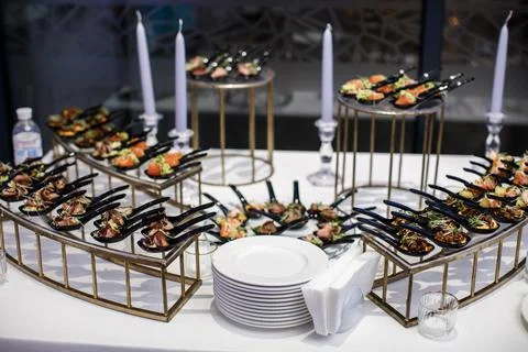 Rows of appetizers and starters on the wedding table Stock Photos