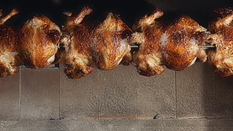 Rows of Authentic Peruvian Rotisserie Chicken Roasting on a Spit Video stock 341439506