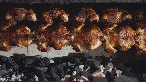 Rows of Authentic Peruvian Rotisserie Chicken Roasting on a Spit Stock Footage 341439625