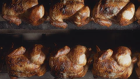 Rows of Authentic Peruvian Rotisserie Chicken Roasting on a Spit Stock-Footage 344985522