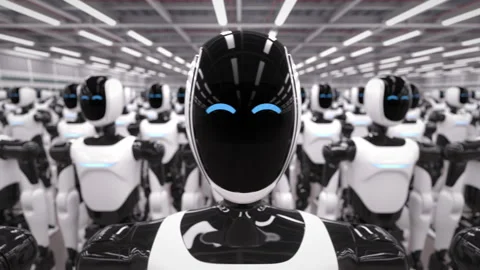 Rows of autonomous AI powered humanoid robots standing in industrial warehouse Stock Footage 328531087