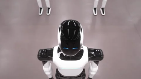 Rows of autonomous AI powered humanoid robots standing in industrial warehouse Stock Footage 329095497
