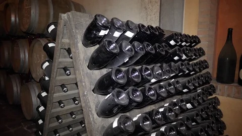 Rows of barrels and aging wine bottles  Stock Footage 105564758