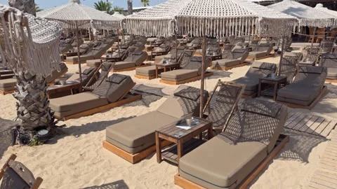 Rows of Beach Sunbeds and Side Tables Under White Canopy Tents Stock Footage 342095841