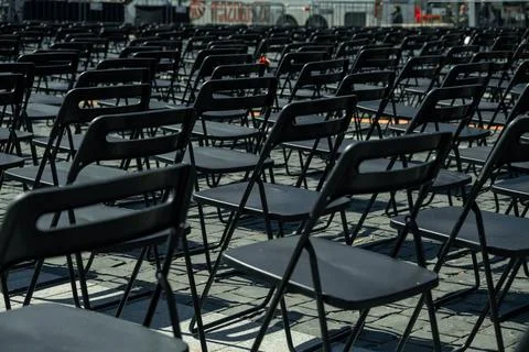 Rows Of Black Plastic Chairs Outside. Summer Open-Air Concert. Stock Photos