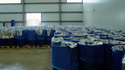 Rows of blue barrels wrapped in foil in warehouse Stock-Footage 347964583