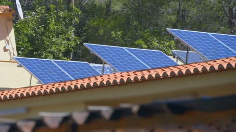 Rows of blue color solar panels on a tiled roof in Spain tilted toward the sun Stock Footage 104110971