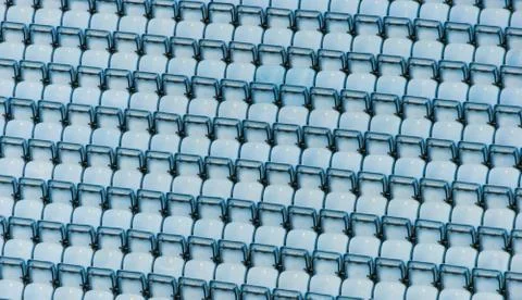 Rows of blue plastic stadium seats. Stock Photos
