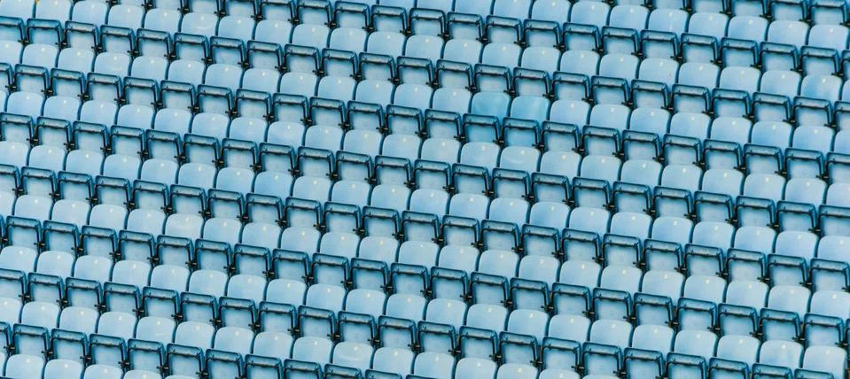 Rows of blue plastic stadium seats. Stock Photos