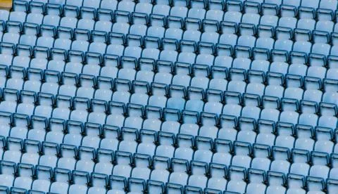Rows of blue plastic stadium seats. Stock Photos