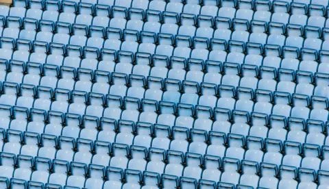 Rows of blue plastic stadium seats. Stock Photos