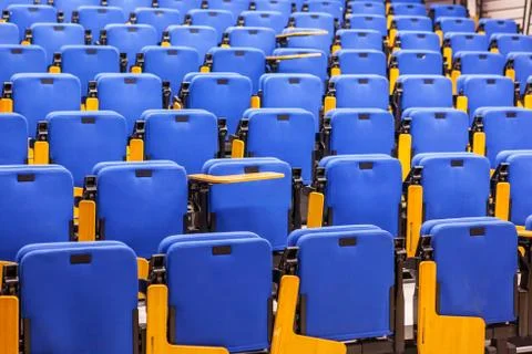 Rows of blue seats in lecture hall. Stock Photos