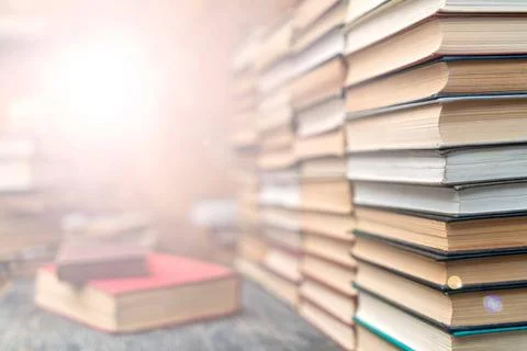 Rows of books in the library. Background for text. Symbol of knowledge and... Stock Photos