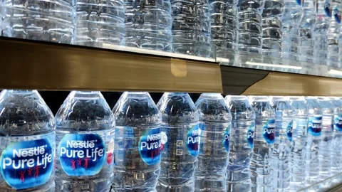 Rows of Bottled Water Neatly Arranged on Supermarket Shelves Stock Footage 305525872