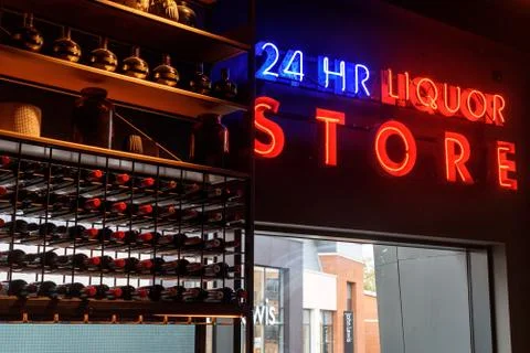 Rows of bottles of alcohol on display at a bar with nobody with 24 hour liquo Stock Photos
