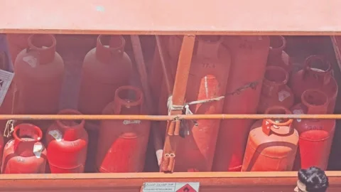 Rows of bright red cooking gas cylinders neatly stored Video stock 313284505