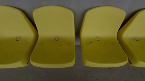Rows of Bright Yellow Chairs Arranged in a Contemporary Modern Setting for Stock Footage 313284125