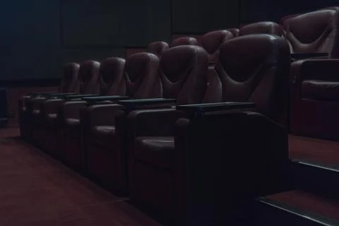 Rows of brown leather armchairs in an empty cinema hall in a movie theater du Stock Photos