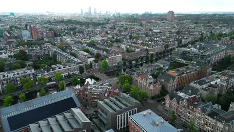 Rows of buildings of Amsterdam intermixed with trees in summer, aerial view Stock Footage 255481921