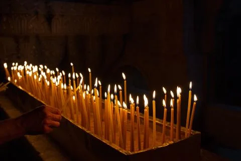 Rows of burning candles . Stock Photos