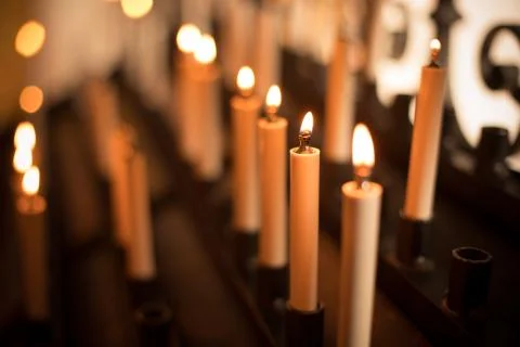 Rows of burning candles Stock Photos