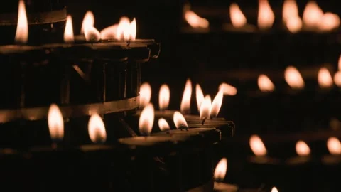 Rows of burning prayer candles in a dark church Stock Footage 344544962