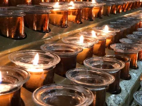 Rows of candles inside of the Milan Cathedral Milan Stock Photos