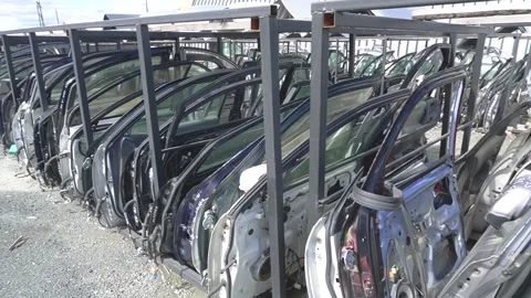 Rows of car doors on car disassembly racks. Metal frames, different colors,.. Stock Footage 321001898