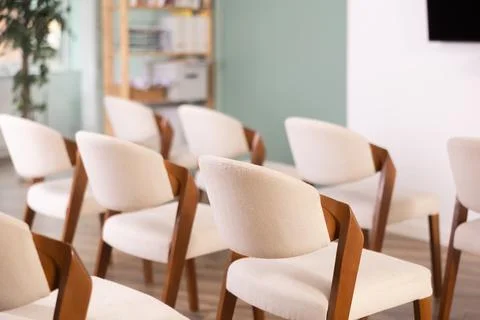 Rows of chairs in empty auditorium Stock Photos