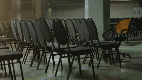 Rows of chairs at empty convention hall center, side view, evening scene 4k HQ Stock Footage 234916769