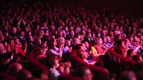Rows of chairs full of people sitting and clapping in Crocus city hall Video stock 63661626