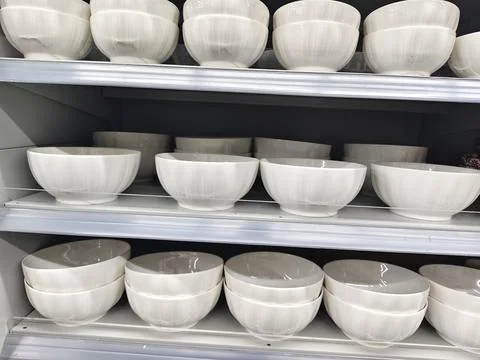 Rows of clean white ceramic bowls neatly stacked Stock Photos