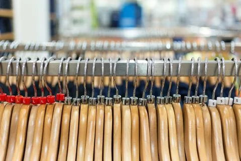 Rows of clothes hangers rack, close up Stock Photos