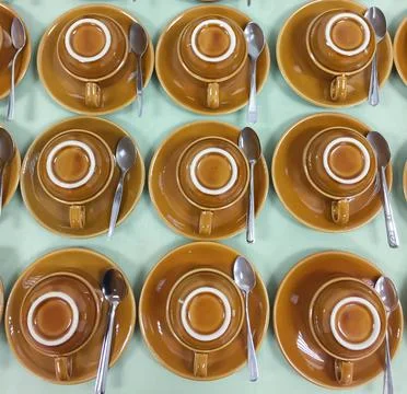 Rows of coffee cups upside down on the saucer on the table. Stock Photos