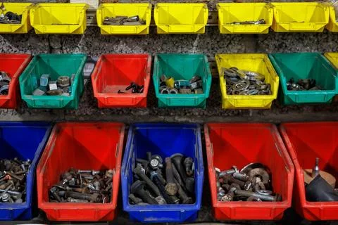 Rows of color coded hardware bins in an indoor repair workshop 스톡 사진
