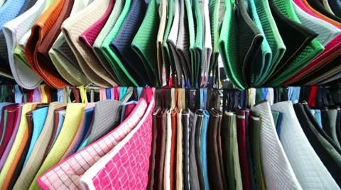 Rows of colored mats under horses saddle in specialized shop Vidéo 38168201