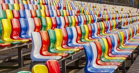 Rows of colored plastic seats at the stadium Stock Photos