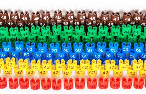 Rows with colored plastic size labels for hangers of a clothing store . Stock Photos