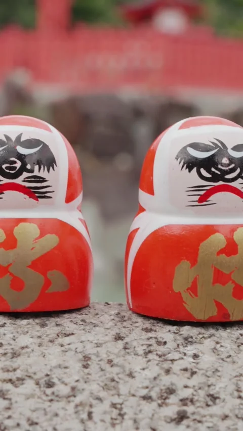 Rows of colorful Daruma dolls rest on stone platform at Katsuoji Temple in Stock Footage 345740887