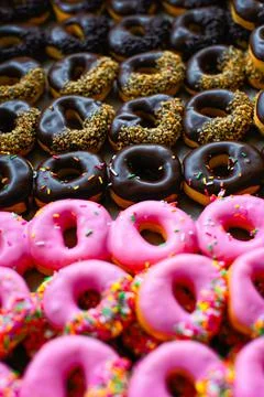 Rows of colorful donuts process in fall color style. Stock Photos