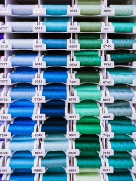 Rows of colorful thread spools, textile background Stock Photos