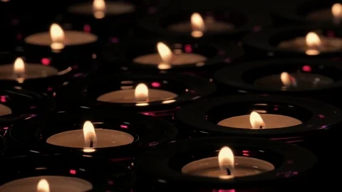 Rows &amp; columns of tealight candles with flickering flames Stock Footage 73953278