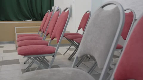 Rows of comfortable cushioned chairs line cozy hall Stock Footage 314884285