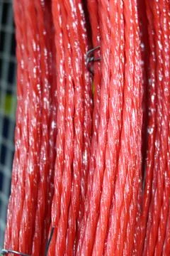 Rows of composite rebar in a roll, red rods. Fittings in rolls. Fiberglass .. Stock Photos