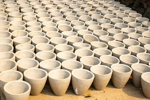 Rows of concrete Pots Stacked for Drying in the Morning Sunlight Stock Photos