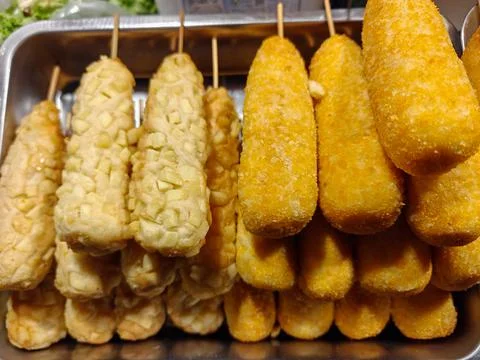 Rows of crispy golden Korean corn dogs Stock Photos