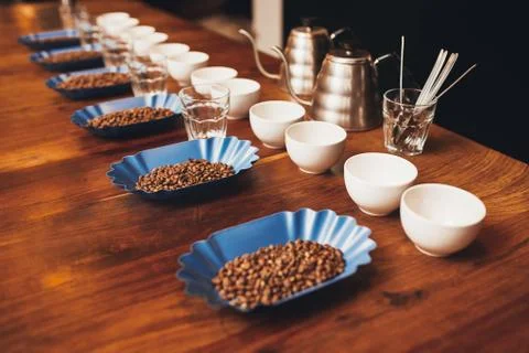 Rows of cups, glasses and containers with coffee beans Stock Photos